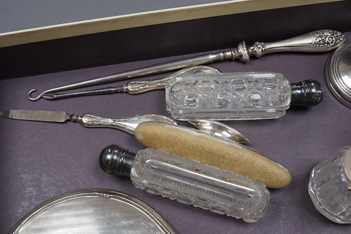 Two silver mounted hand mirrors including Reynold's Angels, Chester, 1899, 26.7cm, together with four silver mounted dressing table implements, a pair of silver mounted dwarf candlesticks and four assorted silver mounted